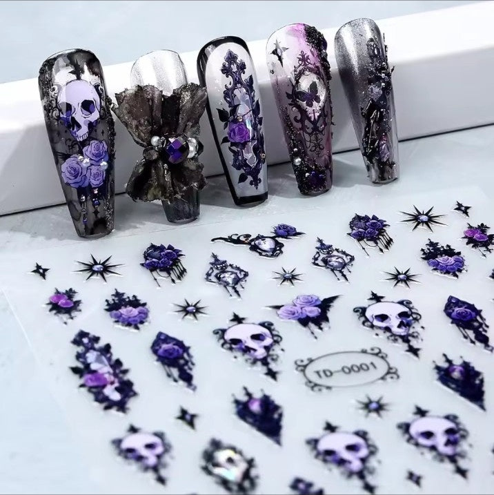 Black and purple gothic skull and rose nail decals shown on nails