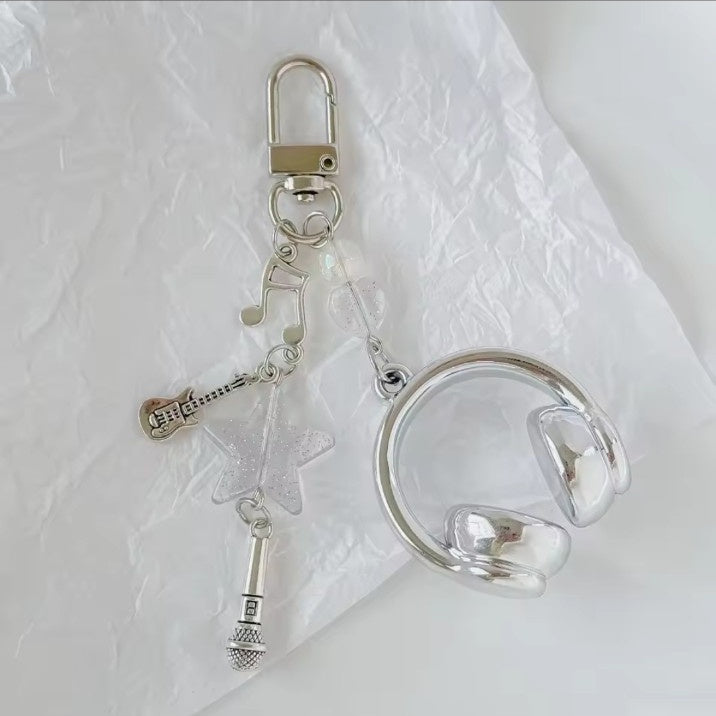 Silver music headphone keychain with guitar star and microphone charms