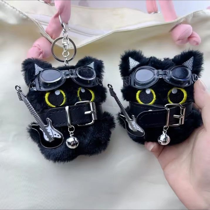 Pair of punk black cat keychains with yellow eyes and goggles