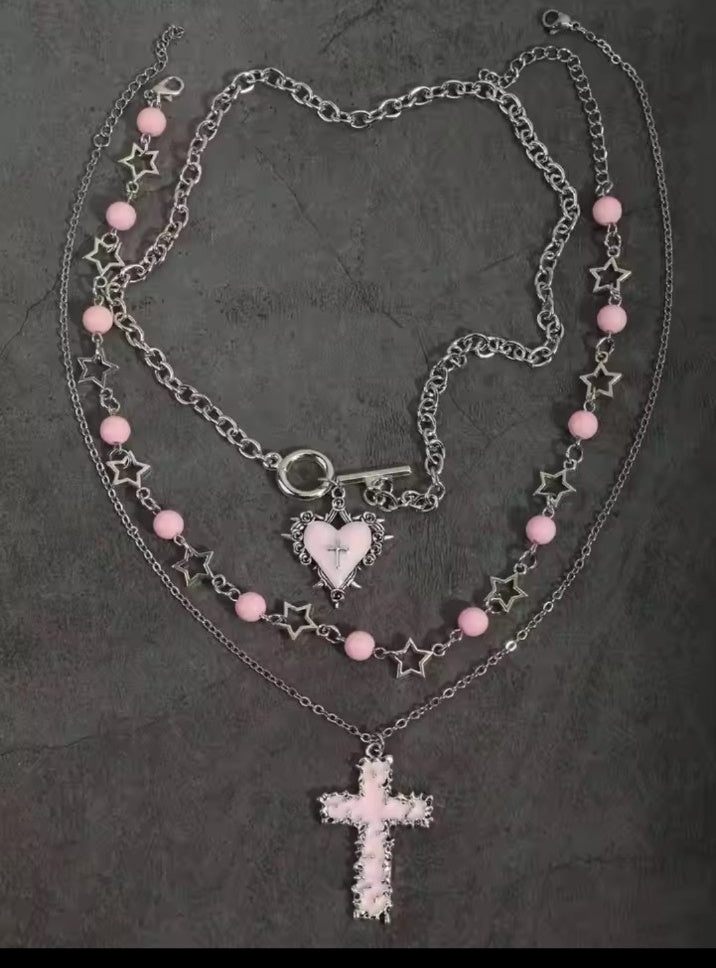 Pink gothic layered necklace set laid flat