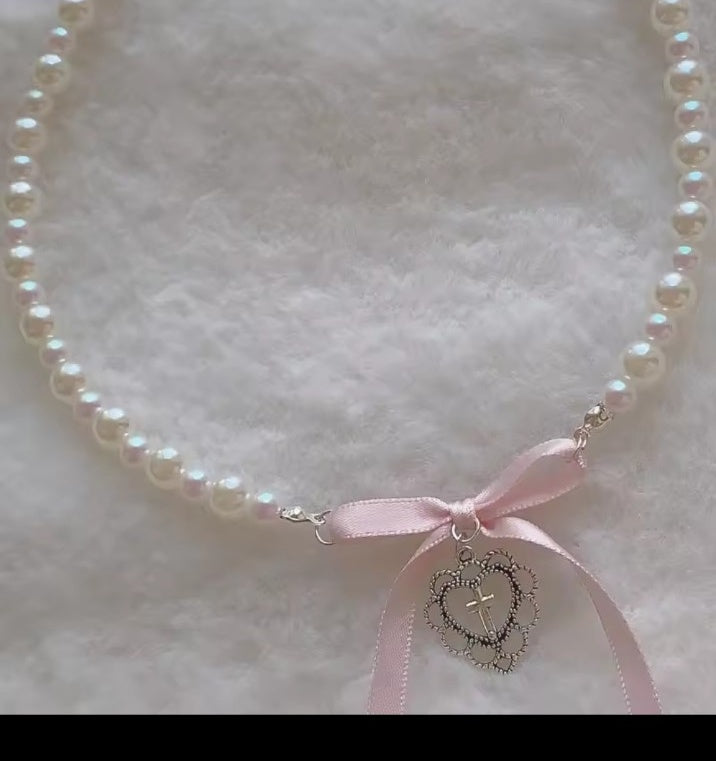 Close up pink ribbon pearl heart pendant necklace