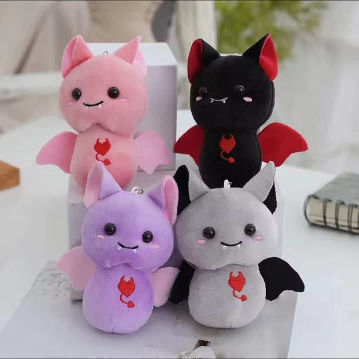 Cute vampire bat plush keychain in pink, black, purple and grey